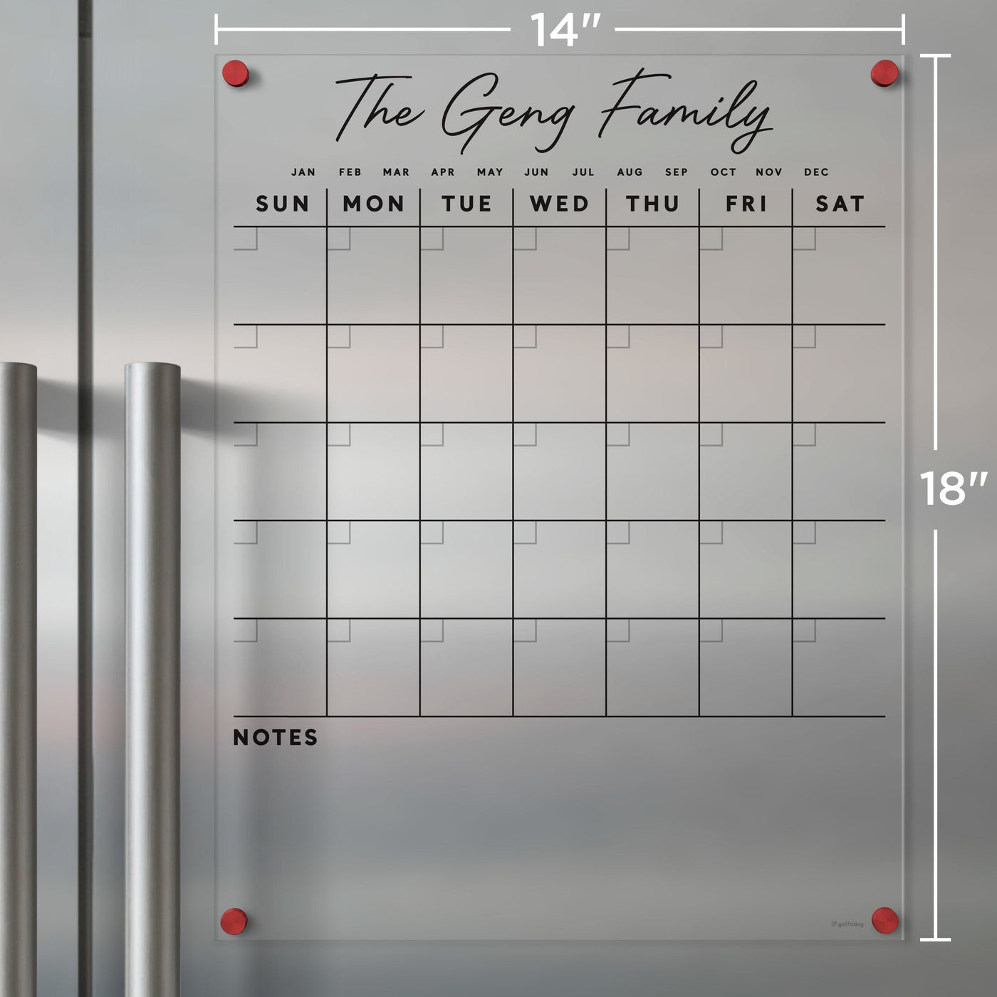 Girl Fridays Clear Acrylic Monthly Calendar for fridge, customized with The Geng Family, displays a monthly grid with daily labeled rows. It includes a NOTES section for wet-erase markers, measures 14x18, and features stylish red corner mounts.