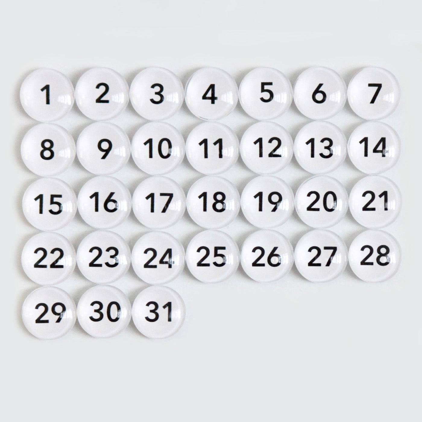 The 9 X 24 Framed Weekly Chalkboard Calendar by CalendarGirlCompany features a sleek grid of white, circular buttons with black numbers from 1 to 31 in a 5x7 pattern; effortlessly marking each day of the month.