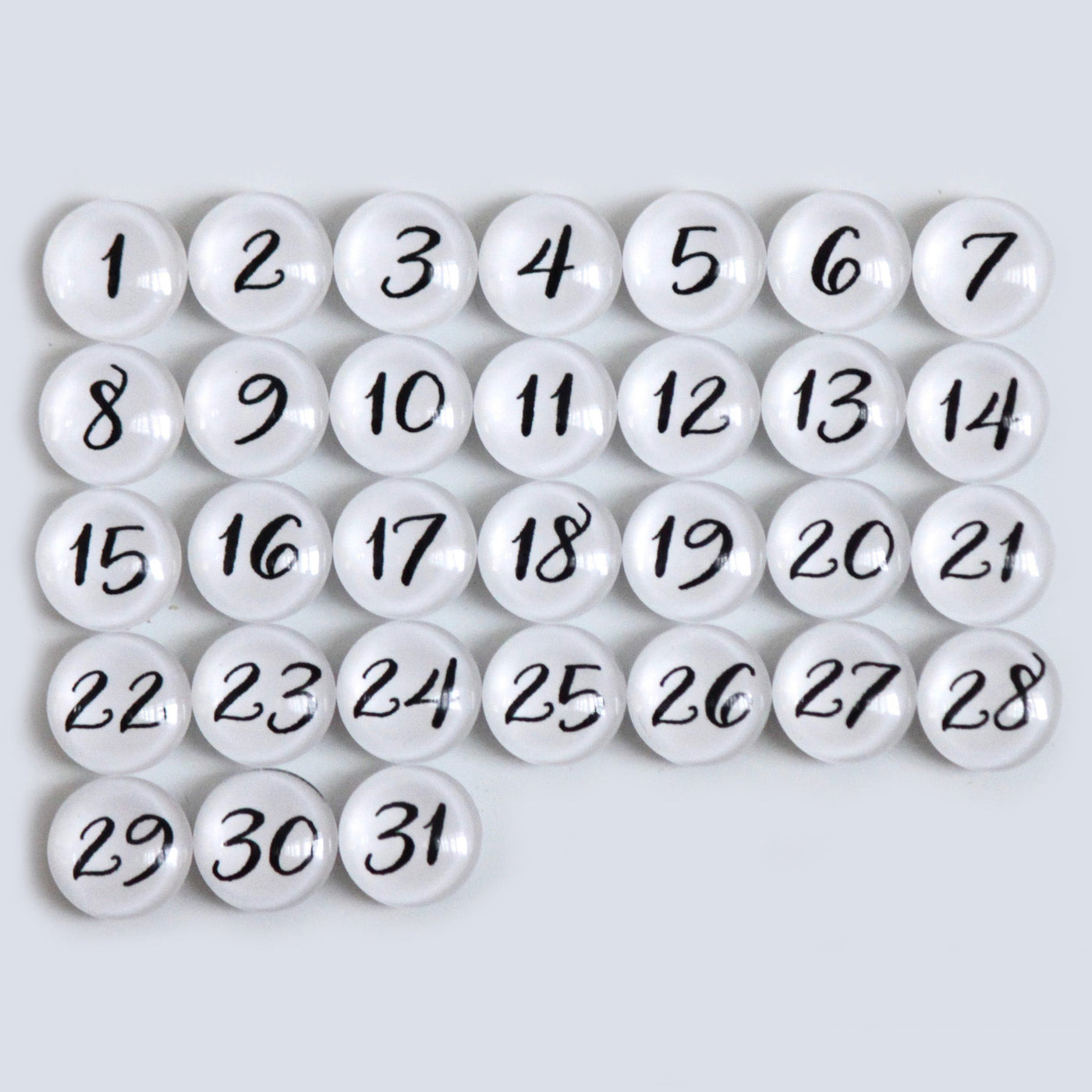 The 9 X 24 Framed Weekly Chalkboard Calendar by CalendarGirlCompany features a grid of white marbles, each numbered 1 to 31 in black ink, perfectly arranged on a light gray background.