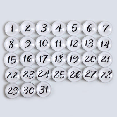 The 9 X 24 Framed Weekly Chalkboard Calendar by CalendarGirlCompany features a grid of white marbles, each numbered 1 to 31 in black ink, perfectly arranged on a light gray background.