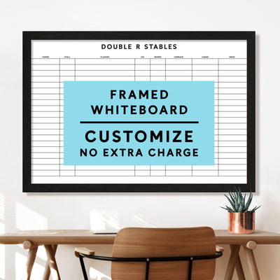 A premium Girl Friday equestrian dry erase whiteboard at Double R Stables features customizable columns for horse details. Nearby, a desk with a chair and potted plant sets the scene. A blue rectangle reads, Framed Whiteboard Customize No Extra Charge, showcasing an elegant solution.