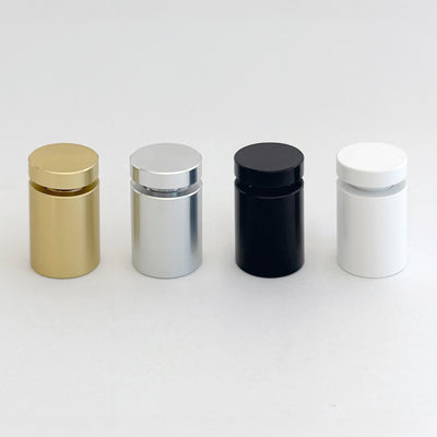Four cylindrical containers in gold, silver, black, and white sit on a white surface with a glossy finish and flat tops. They stylishly organize items and are an ideal match for Girl Friday Shops Modern Cork Board with custom cutting.