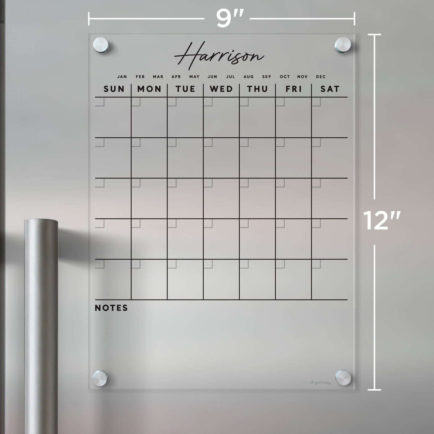 The Clear Acrylic Monthly Magnetic Fridge Calendar by Girl Friday, customizable with a family name in script font, is perfect for weekly organization. Displaying days from Sunday to Saturday and months January to December, it features a notes section and measures 9x12 inches, ideal for wet-erase markers.