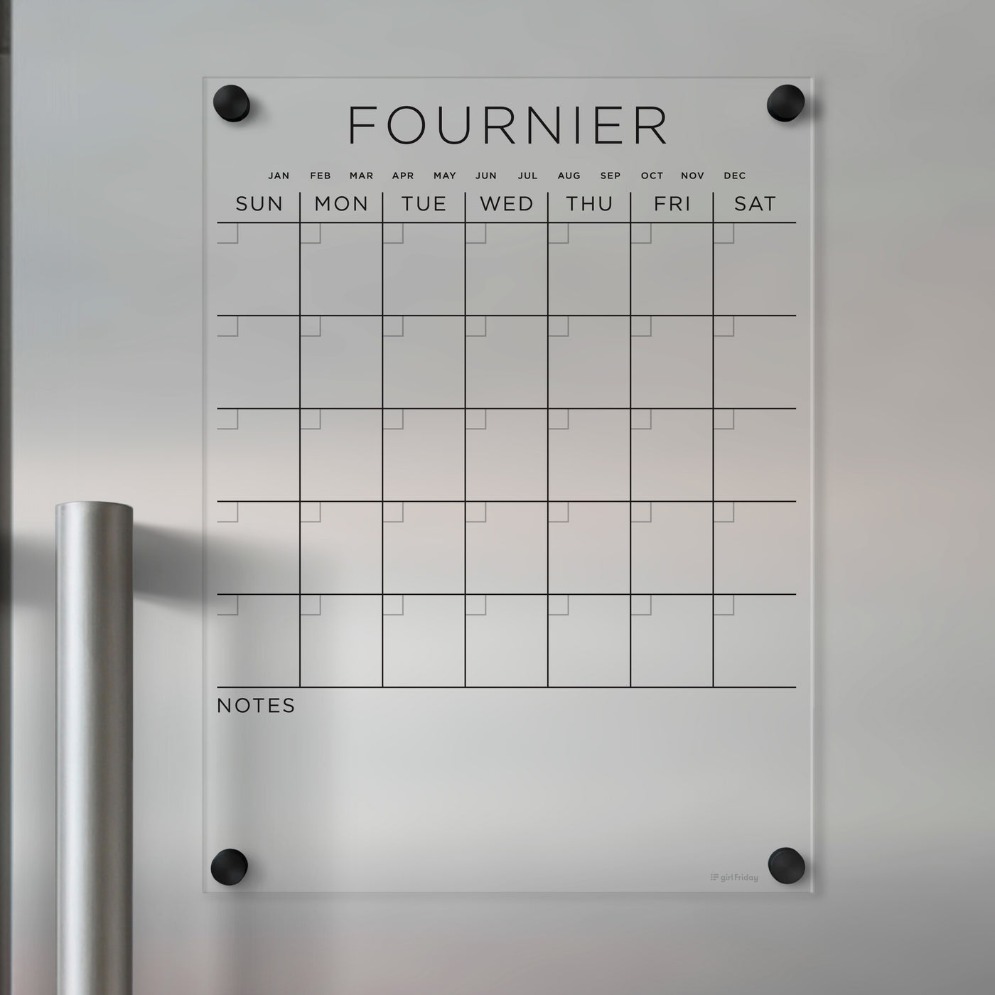 The Clear Acrylic Monthly Magnetic Fridge Calendar | Custom Family Name by Girl Friday is a transparent, customizable calendar with labeled months and days. It has sections for daily plans, a Notes area, and mounts to metallic surfaces, ideal for wet-erase markers.