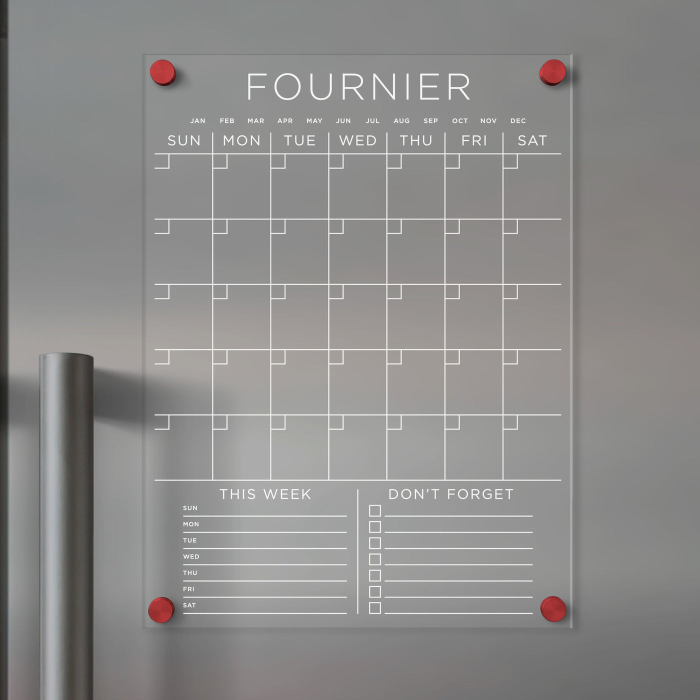 The Clear Acrylic Monthly Fridge Calendar by Girl Friday features daily columns, monthly rows, and sections labeled This Week and Dont Forget with checkboxes. Customizable with your family name, its perfect for wet-erase markers and is attached using red pins.