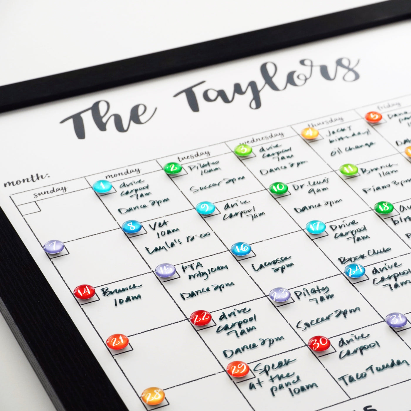 CalendarGirlCompanys 18 x 24 Framed Whiteboard Calendar, #18420, features an acrylic surface and colorful magnets for marking activities. Chalk ink markers set dates and events in a black frame for an organized touch.