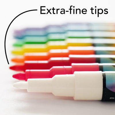 A close-up of Girl Friday Shops Chalk Ink Multi-Colored Markers reveals their extra-fine tips, with vibrant colors from red to purple. The text Extra-fine tips and an arrow highlight their perfect use for brightening fridge calendars.