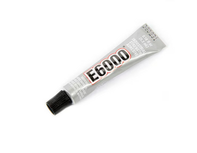 A small silver tube of E6000 glue, sealed with a black cap, sits against a white backdrop. Prominently displaying red, white, and black text, it promises an adhesive bond capable of securing Girl Friday Shops strong neodymium disk magnets.
