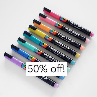 Eight Girl Friday Chalk Ink Vibrant Markers, glowing in shades of pink, orange, yellow, green, blue, and purple, are displayed diagonally on a white surface. A bold text overlay announces 50% off!.