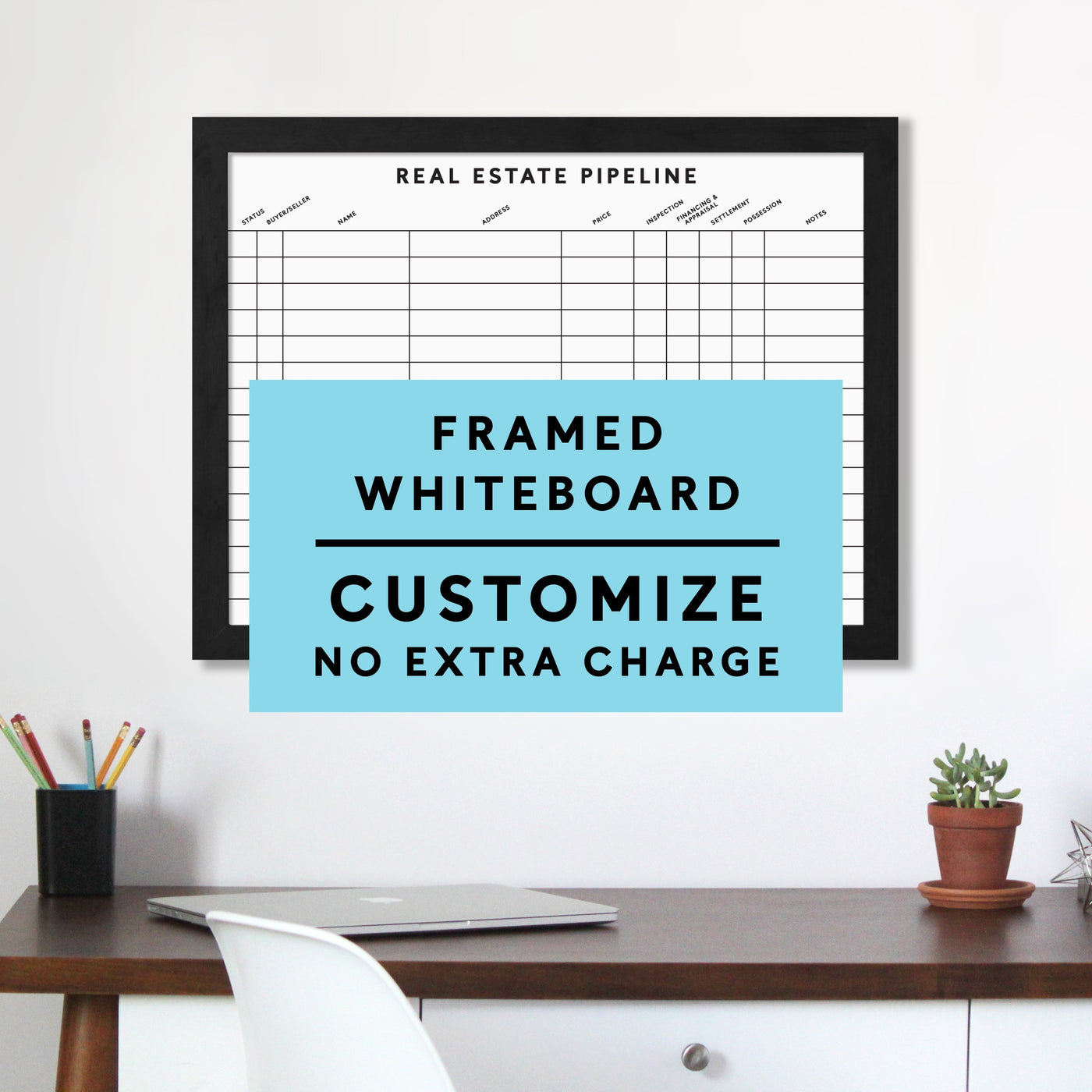 A Real Estate Pipeline Framed Whiteboard by Girl Friday Shop hangs above a desk featuring pencils in a cup, a plant, and a book. Customize your small-sized board with premium acrylic at no extra charge.