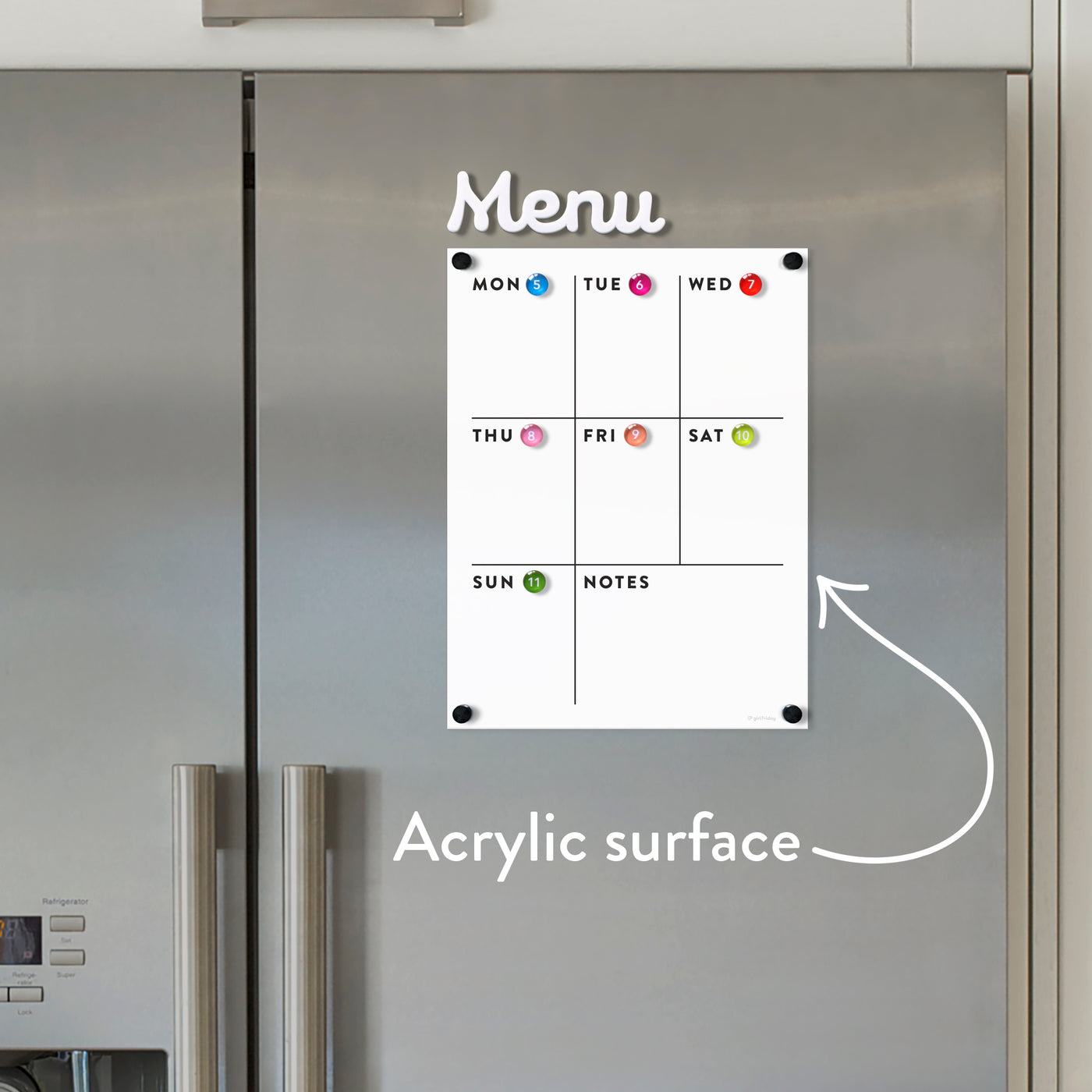The White Acrylic Weekly Fridge Menu Board with Notes by Girl Friday Shop is elegantly displayed on a stainless steel fridge. It features days labeled from Monday to Sunday, vibrant magnets, and a playful arrow highlighting Acrylic surface, simplifying meal planning on the dry erase board.