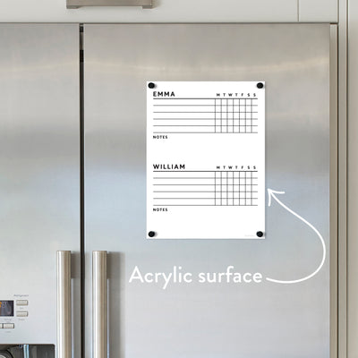 The Girl Friday Shops customizable acrylic fridge chart features premium neodymium magnets. It’s divided for “Emma” and “William,” with slots for days and notes, plus a handwritten arrow to enhance organization.