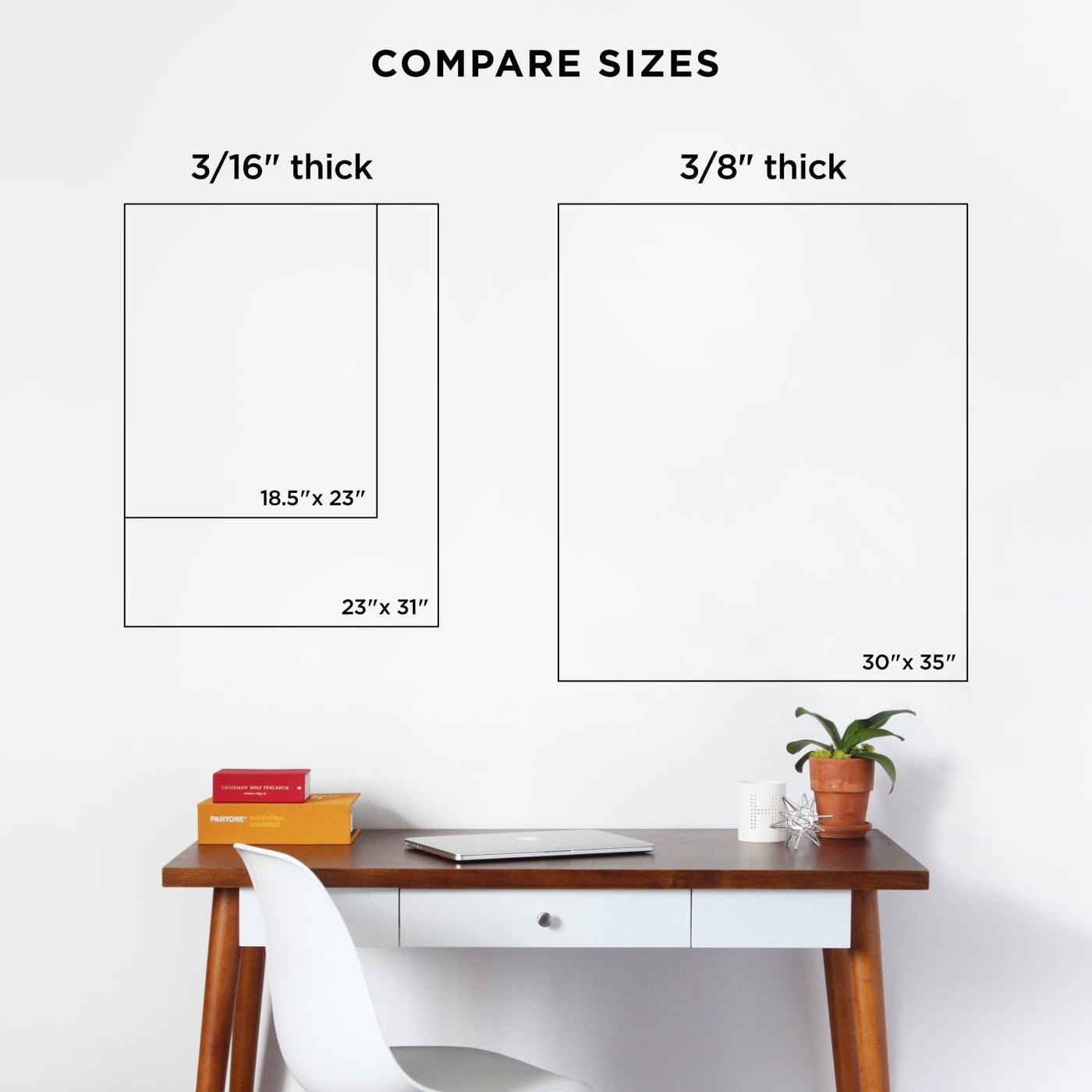 On the left above the desk are prints (3/16 thick, 18.5 x 23 and 23 x 31), while on the right is a customizable clear acrylic monthly wall calendar by Girl Friday Shop (3/8 thick, 30 x 35). The desk is complemented by a white chair, books, and a potted plant for a sleek finish.