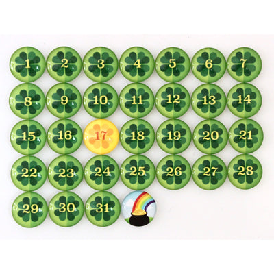 Explore Girl Fridays Number Magnets for March! Shamrocks | St. Patricks Day collection: glass magnets in a calendar grid numbered 1-31, with green clover designs, except the gold 17th for St. Patrick’s Day and a magnet below 31 featuring a pot of gold and rainbow.