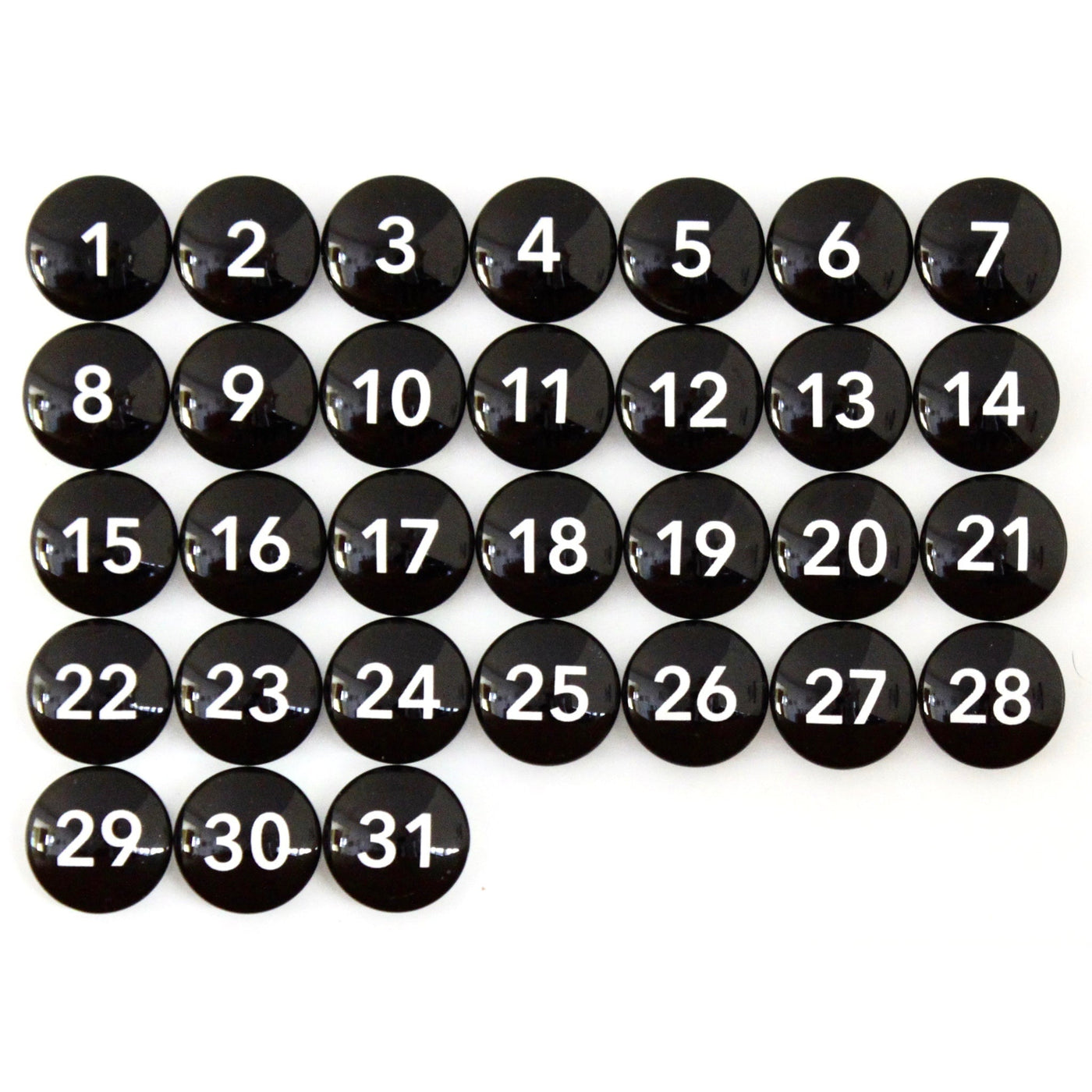 Thirty-one Number Magnets - Black by Girl Friday, featuring white numbers from 1 to 31 on sleek black glass, arranged in a calendar-like grid.