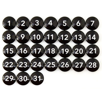 Thirty-one Number Magnets - Black by Girl Friday, featuring white numbers from 1 to 31 on sleek black glass, arranged in a calendar-like grid.