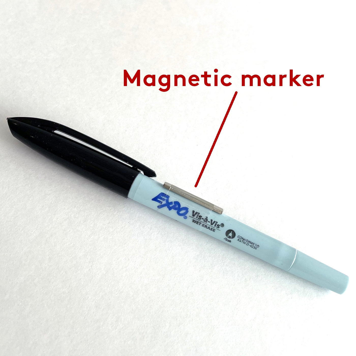 A Girl Friday wet-erase magnetic marker, featuring a blue body and black cap, is shown on a white surface. A red arrow labeled Magnetic Marker points to it, making it ideal for clear acrylic calendars or stainless steel plates.