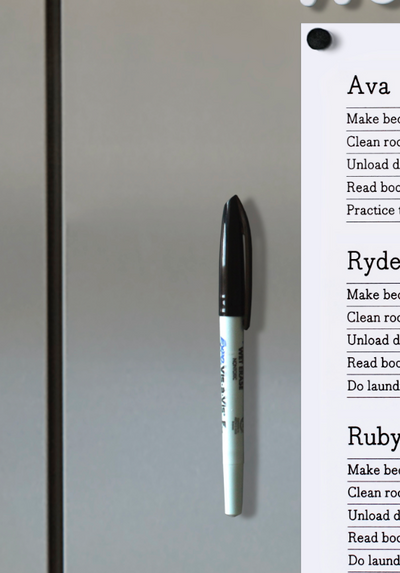 A Girl Friday Make any marker magnetic! product, in black and white, uses a thin magnet to cling to metal surfaces. A partially visible list shows names and tasks like making a bed and unloading the dishwasher.
