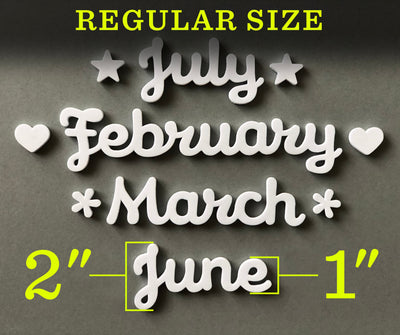 The magnetic month words by Girl Friday Shop feature REGULAR SIZE in yellow, with July, February, and March adorned with stars and hearts crafted from high-density foam. June appears smaller, indicating sizes of 2 and 1, ideal as calendar accessories on a gray background.